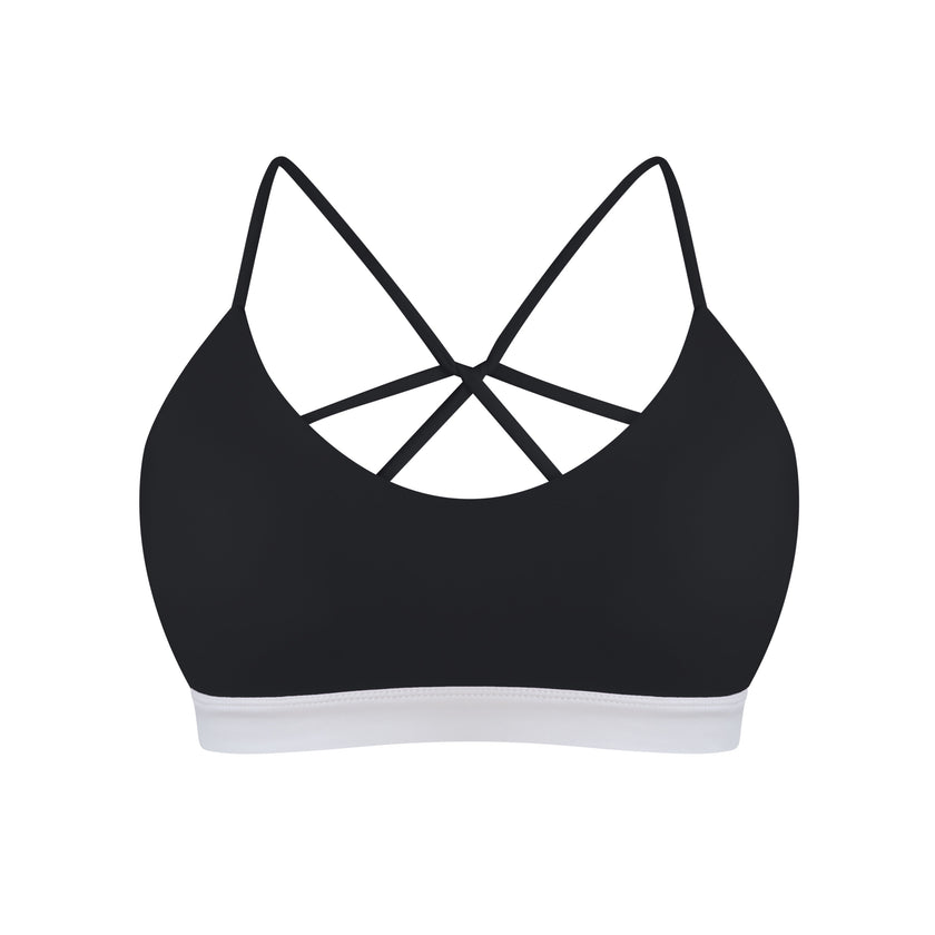 Black high-support swimming top with white trim on a white background