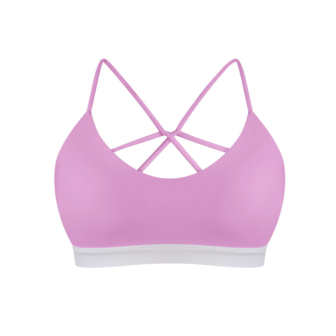 Purple sports bra with criss-cross straps on a white background